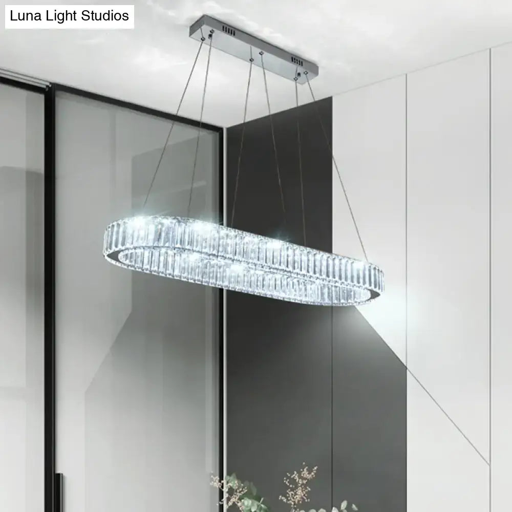 A modern oval crystal ceiling light with chrome finish and stainless steel design for restaurant islands