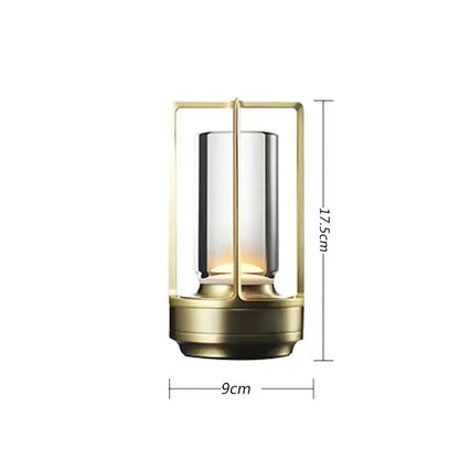 A sleek brass-finished decorbites™ led crystal table lamp with cylindrical glass and warm led lighting for bedside use