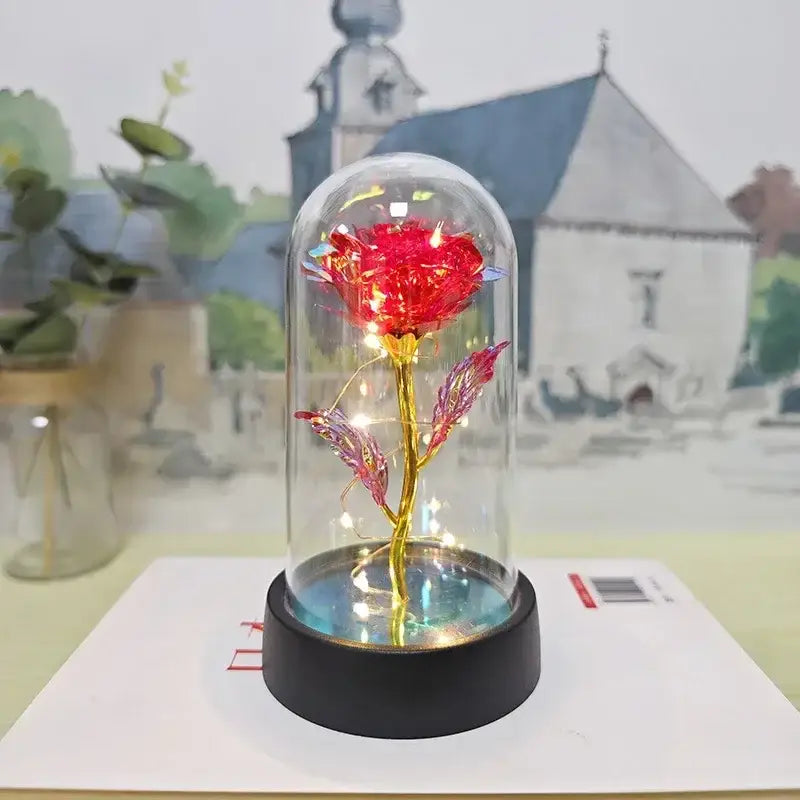 Decorbites™ led eternal rose light features a glowing red eternal rose with gold stem in a glass dome on black base