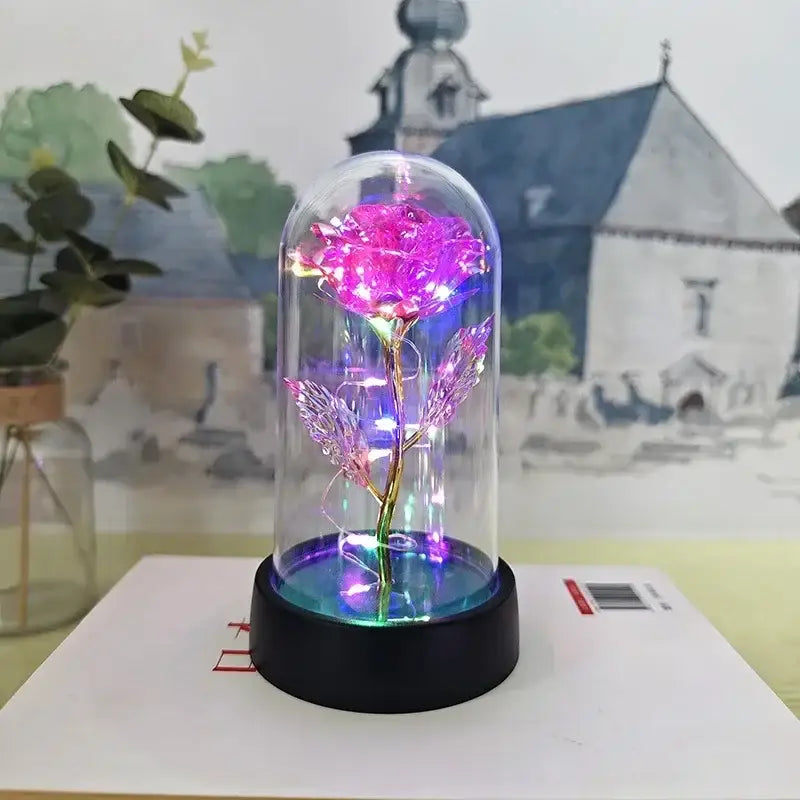 DecorBites™ LED eternal rose light glowing pink encased in a clear glass dome with black base for weddings and Valentine’s Day