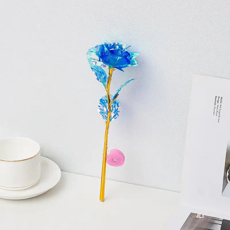 DecorBites™ eternal rose light with a vibrant blue translucent glass rose, golden stem, and pink heart charm for weddings