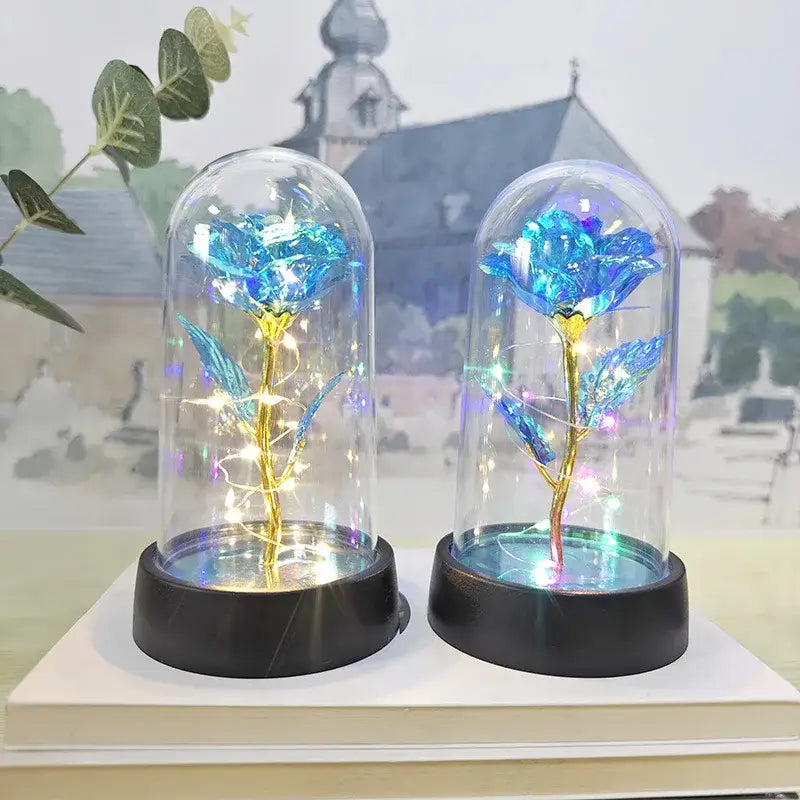 Two illuminated blue roses with golden stems encased in glass domes decorbites™ led eternal rose light for valentine’s day