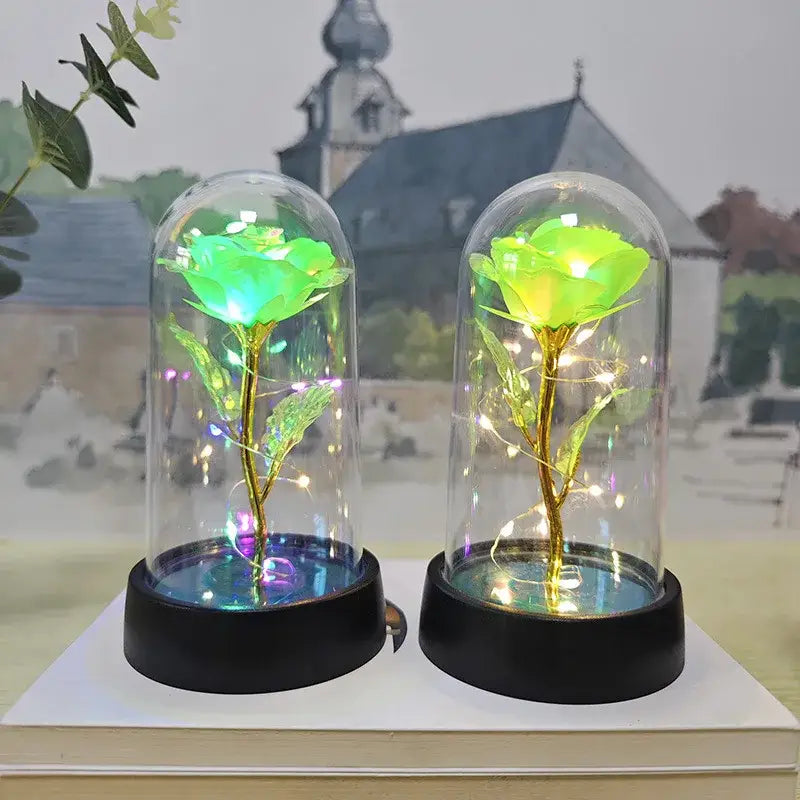 Decorbites™ eternal rose light featuring two green led roses with golden stems in glass domes on black bases for valentine’s day