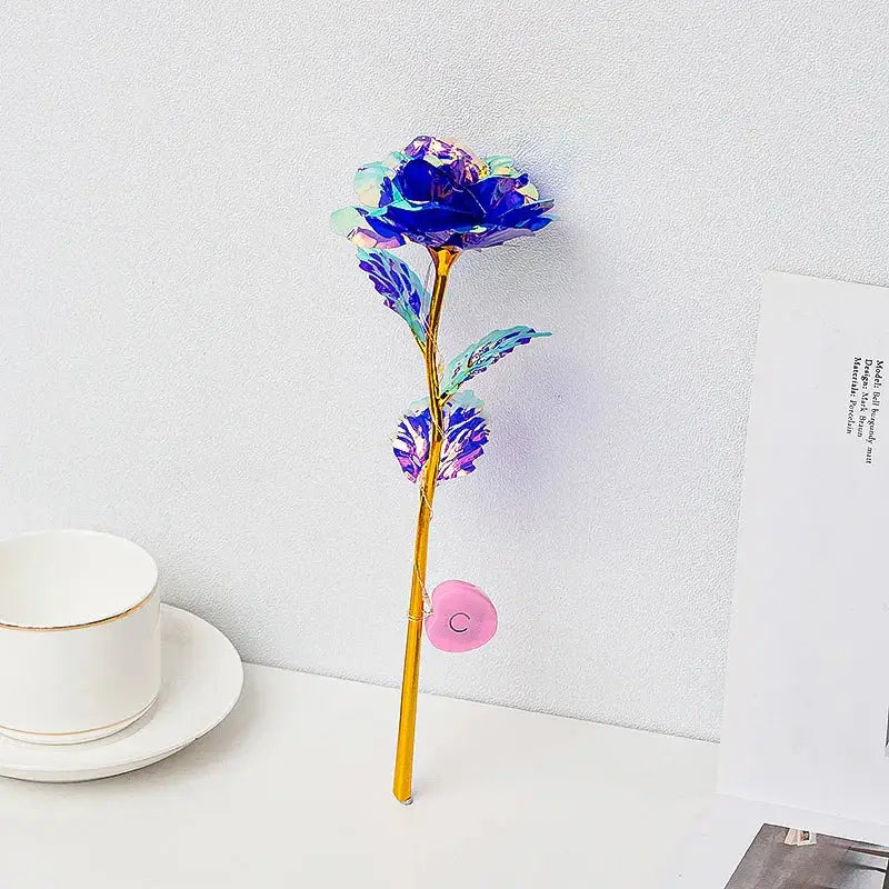 DecorBites™ LED eternal rose light with shimmering blue iridescent petals and golden stem for Valentine’s Day and weddings