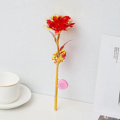 Decorbites™ led eternal rose light featuring a vibrant red and yellow metallic rose with gold stem and pink heart charm