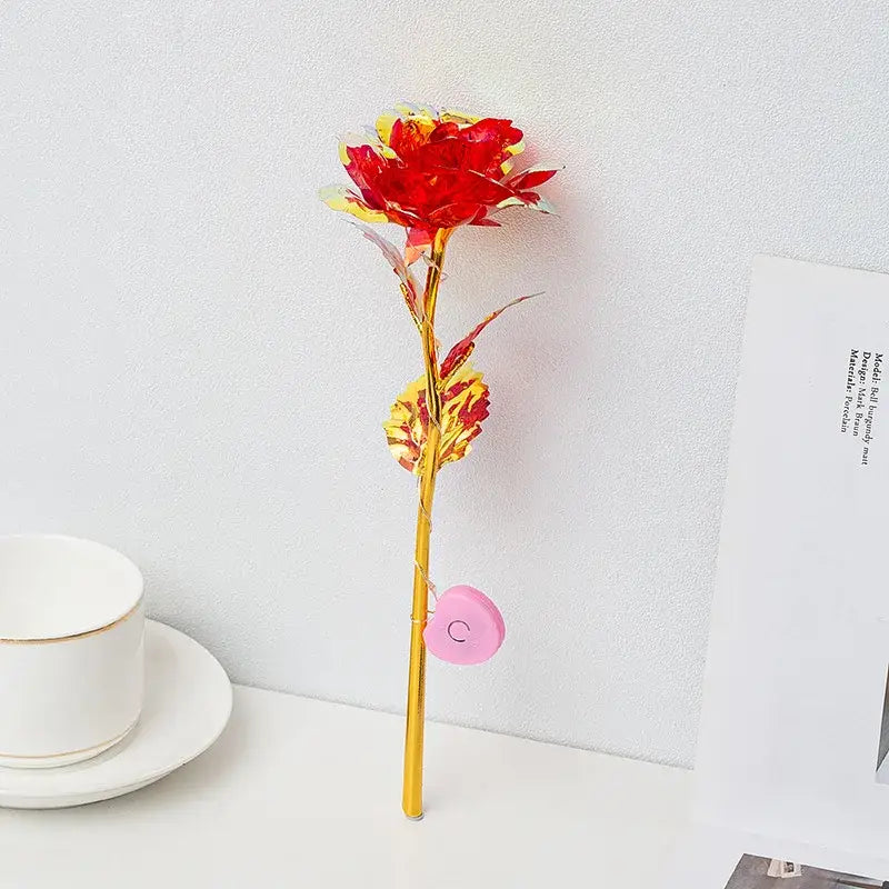 Decorbites™ led eternal rose light featuring a vibrant red and yellow metallic rose with gold stem and pink heart charm