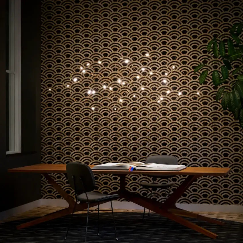 A modern wooden table with a sleek x-shaped base complements the decorbites™ led firefly chandelier engineering minimal design