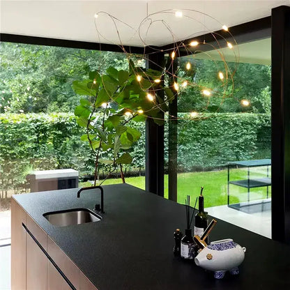 A modern DecorBites™ LED firefly chandelier with thin copper wires and warm bulbs featuring engineering minimal design