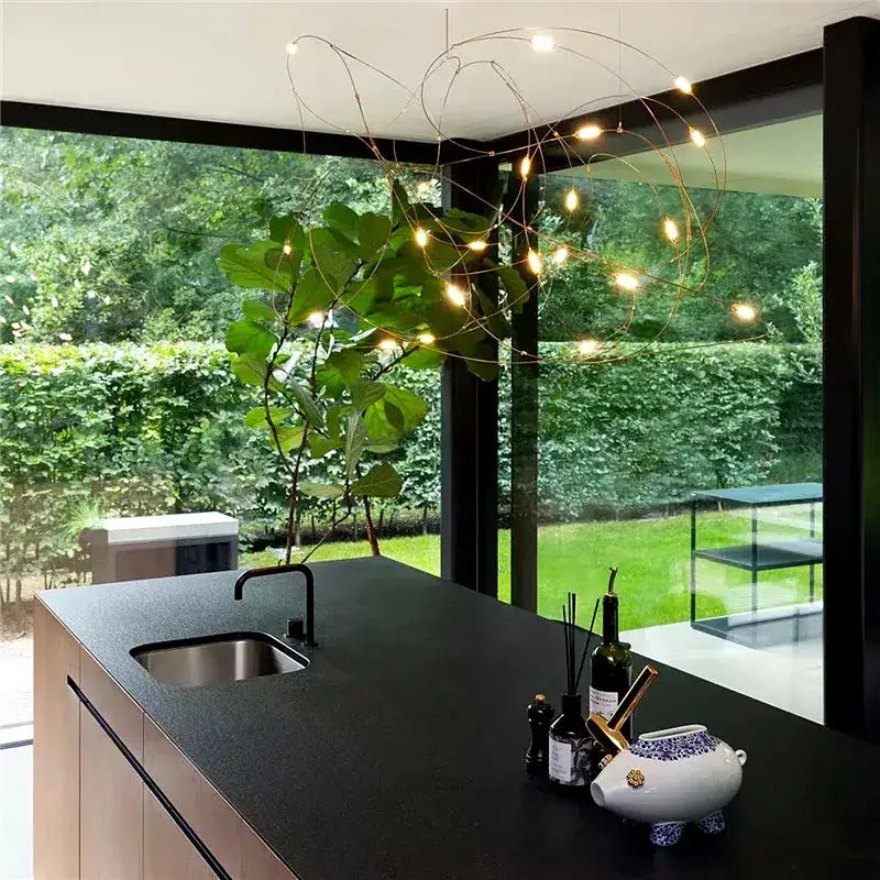 A modern DecorBites™ LED firefly chandelier with thin copper wires and warm bulbs featuring engineering minimal design