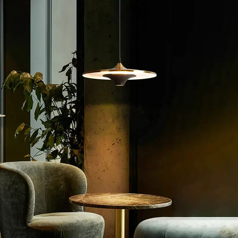 A sleek decorbites led flying saucer pendant light with metallic finish and warm glow for indoor use