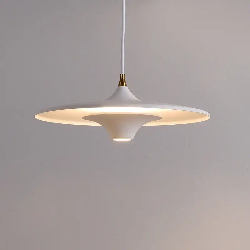A sleek white decorbites led flying saucer pendant light with a minimalist disc design and gold-toned accent for indoor lighting