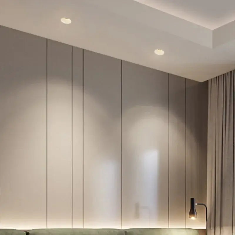 Modern gray vertical panelled wall with subtle metallic trim illuminated by decorbites led frameless recessed downlight