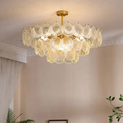 A golden DecorBites led frost chandelier with multiple tiers of translucent frost glass shell shades for home decor