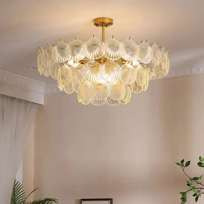 A golden DecorBites led frost chandelier with multiple tiers of translucent frost glass shell shades for home decor