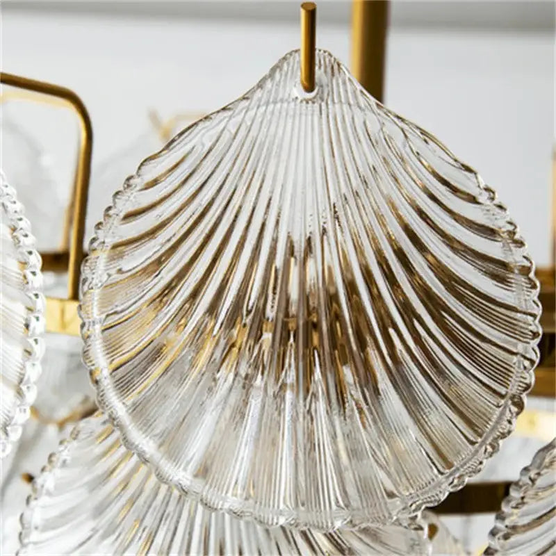Clear glass seashell-shaped dish with gold-toned ridges and hanging loop for decorbites led frost glass shell chandelier