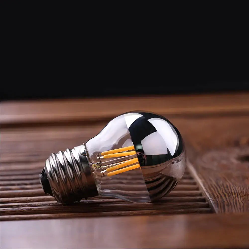 A sleek silver bowl decorbites led g45 globe bulb with reflective glass and visible filament strands