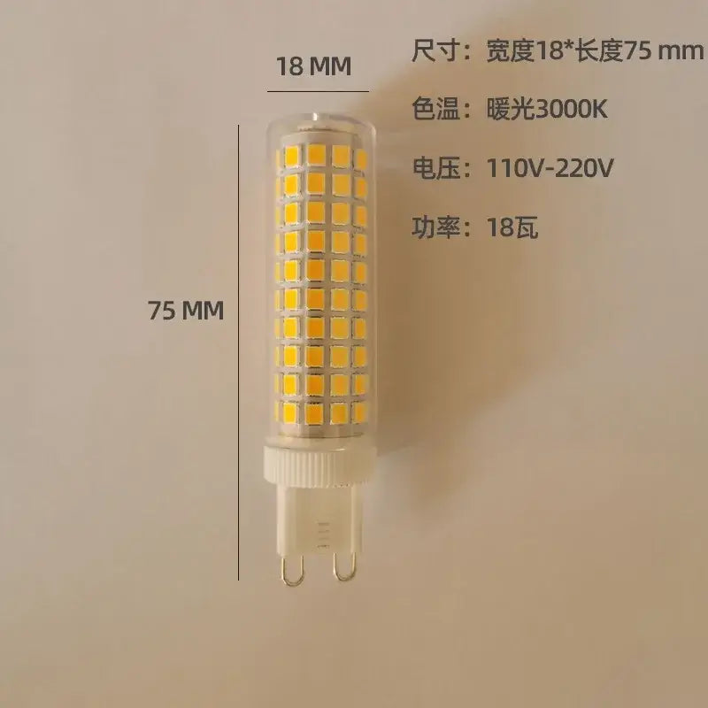 A 75mm tall decorbites led g9 bulb with a clear glass body and warm natural white yellowish square leds arranged vertically
