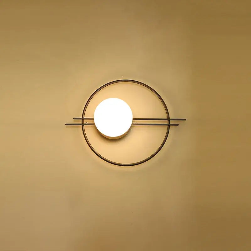 Minimalist decorbites led g9 wall sconce with warm white illuminated disc encased in black metal for modern living spaces