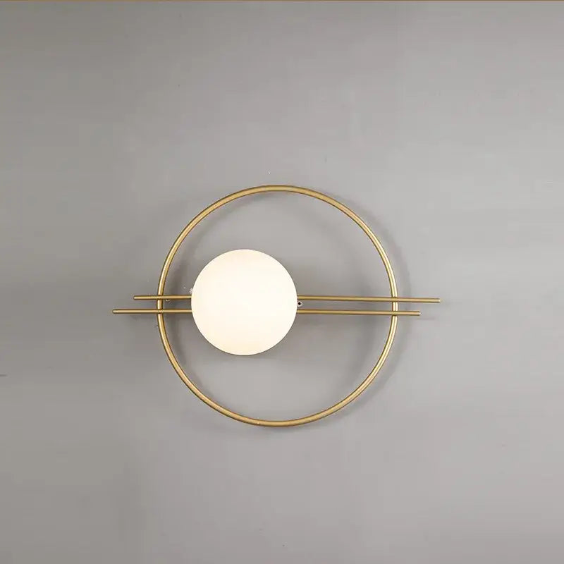 Modern gold-toned decorbites led g9 wall sconce with circular frame and off-white spherical glass shade for indoor lighting