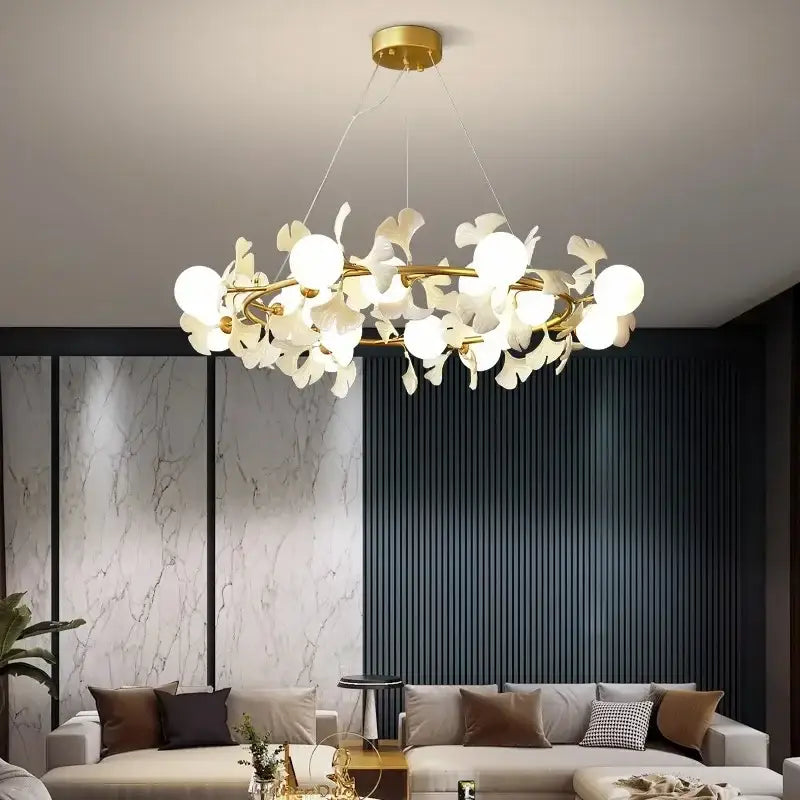 Gold-toned decorbites led gingko ceiling chandelier with white petal-shaped glass orbs in a circular cluster for modern rooms