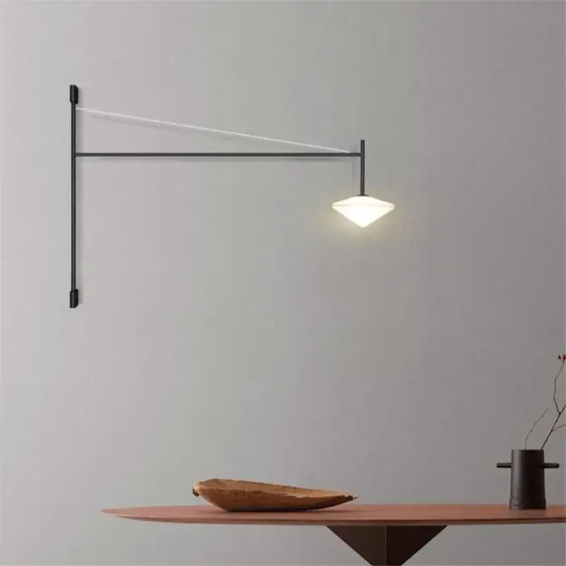 Black metal wall-mounted DecorBites™ LED glass art wall lamp with sleek angular design and warm white illuminated shade