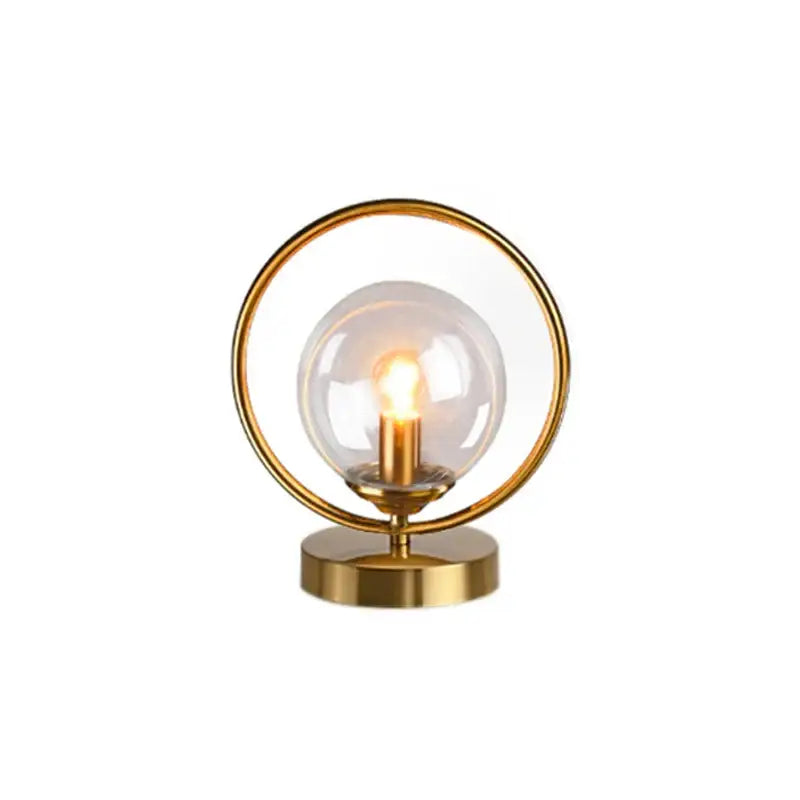 DecorBites™ LED glass ball brass ring table lamp with gold-toned circular base and clear glass globe for stylish lighting