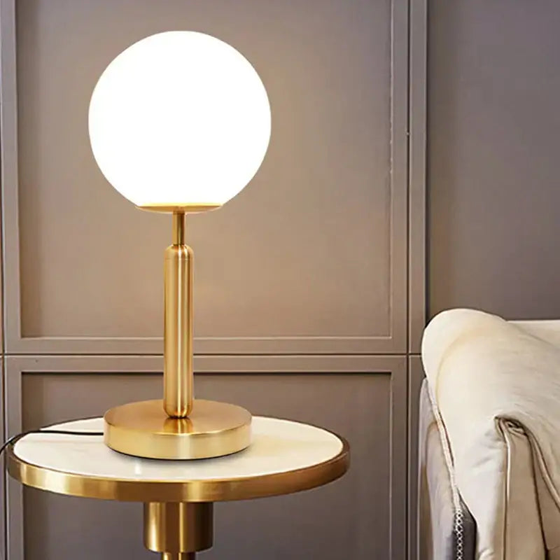 Gold-finished spherical led glass ball table lamp by decorbites for luxury home decor bedrooms and offices
