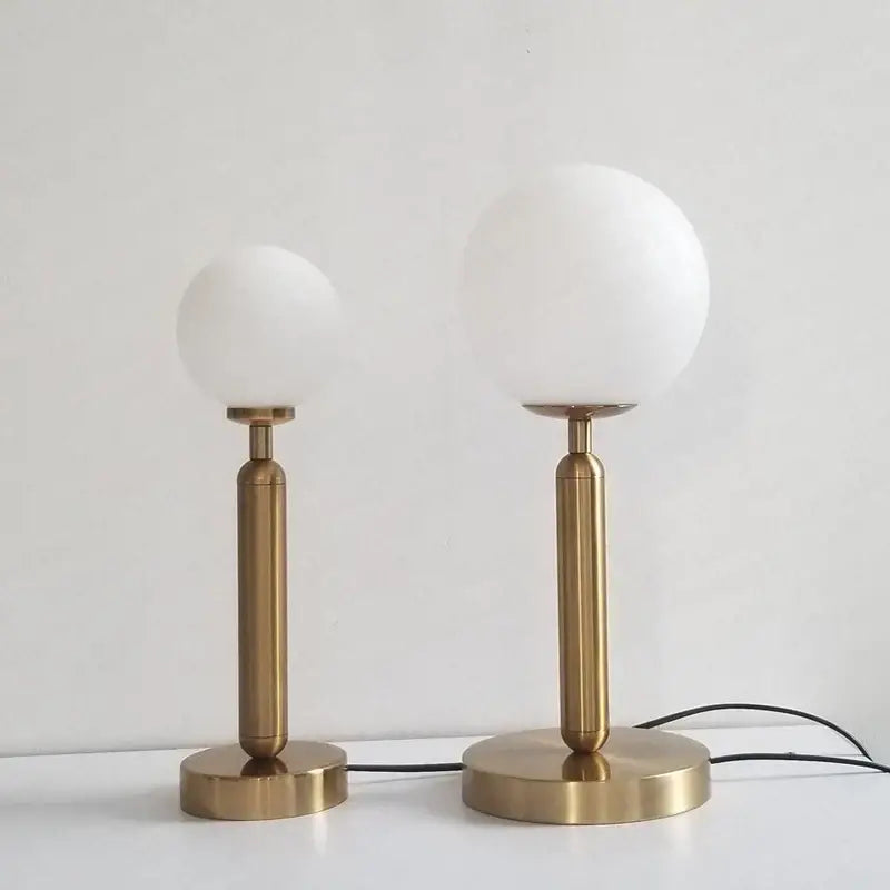 Two minimalist brass table lamps with frosted white glass shades from decorbites led glass ball collection for luxury decor