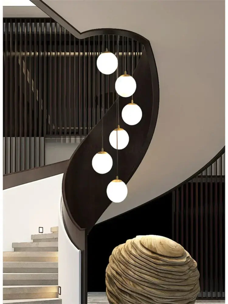Modern minimalist decorbites led glass ball chandelier with five white glass bulbs and gold chains on black metal frame