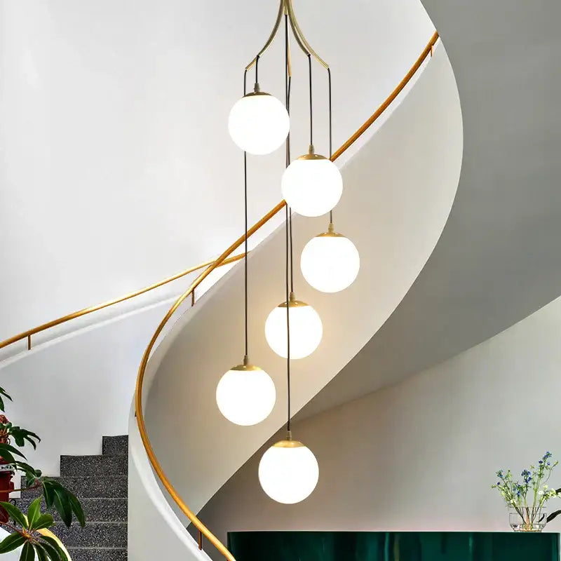 Modern brass-finished decorbites led glass ball chandelier with five frosted globes for living room dining decor