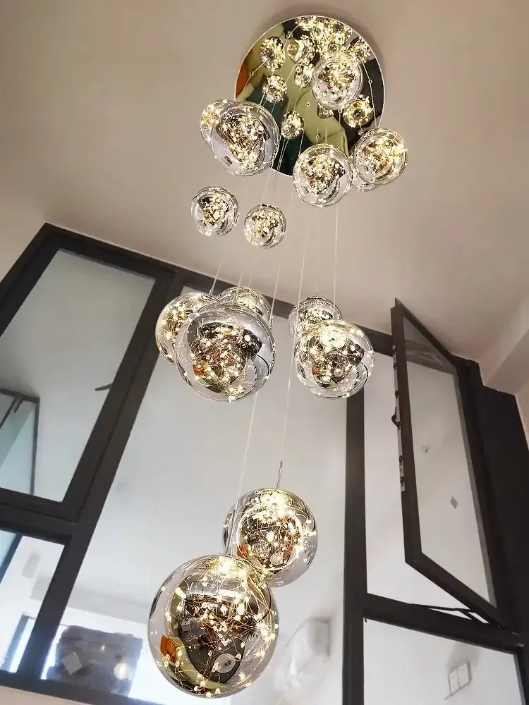 A decorbites led glass ball chandelier with multiple spherical glass orbs and intricate lighting for duplex villa living room