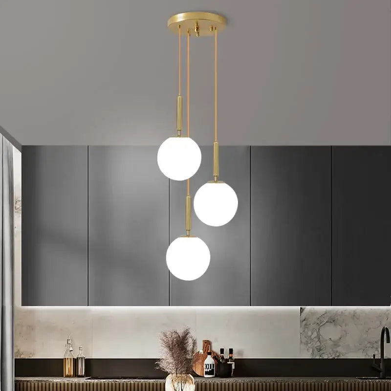 Modern gold-toned DecorBites LED glass ball chandelier with three white spherical LED glass ball bulbs for home decor