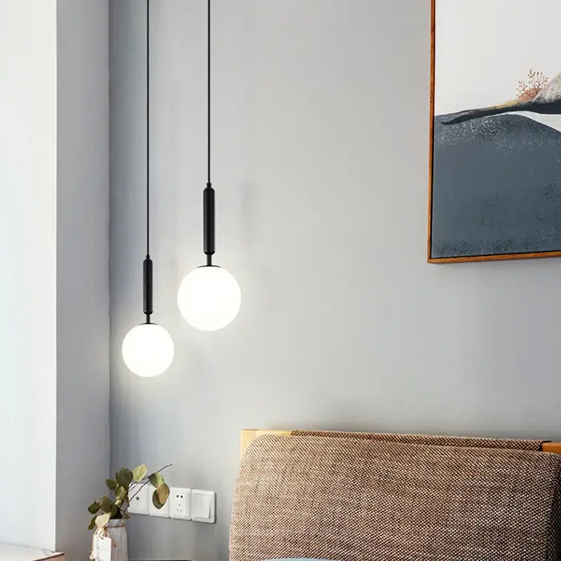 Two minimalist black pendant lights with spherical white glass shades from decorbites led glass ball chandelier