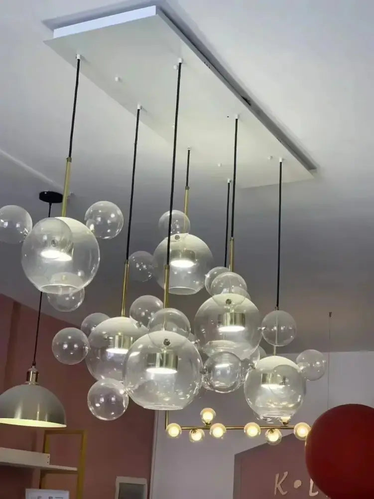 Modern glass bubble chandelier with gold-toned metal accents and black cords decorbites led glass pendant lights for living room