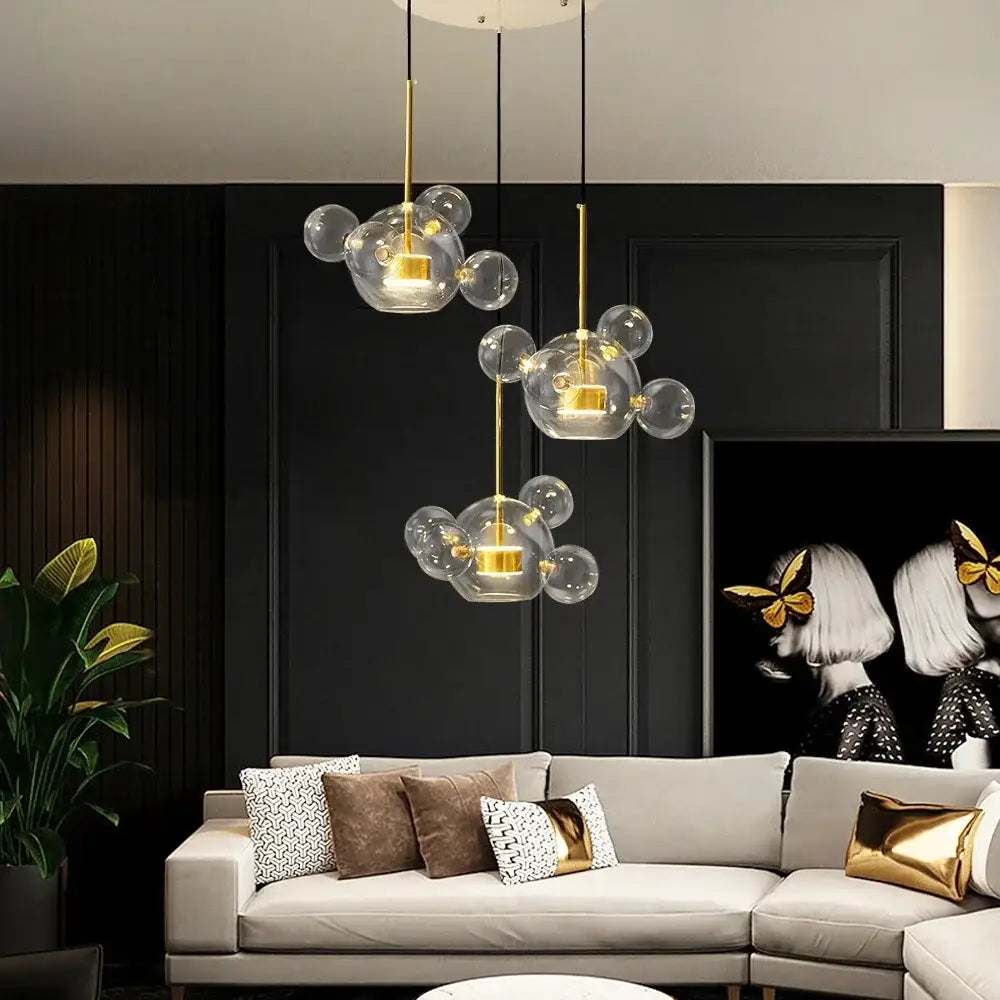 Three modern decorbites led glass pendant lights with gold accents and clear led glass ball bulbs for living room lighting