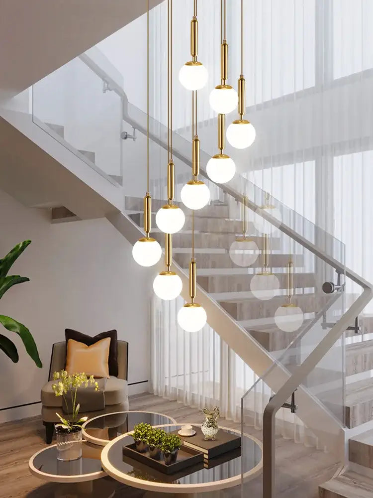 Gold-toned decorbites led glass ball chandelier with spherical white glass shades for modern indoor lighting