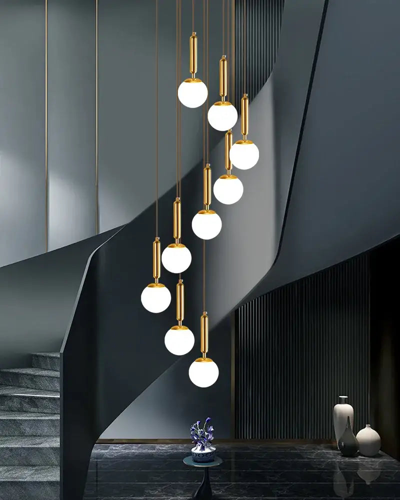 Golden spherical pendant lighting featuring frosted glass globes in a decorbites led glass ball chandelier for indoor use