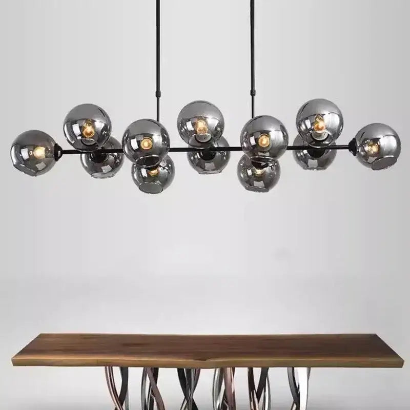 Modern chrome-finished decorbites led glass pendant light with black metal arms and hanging cords for dining and kitchen decor