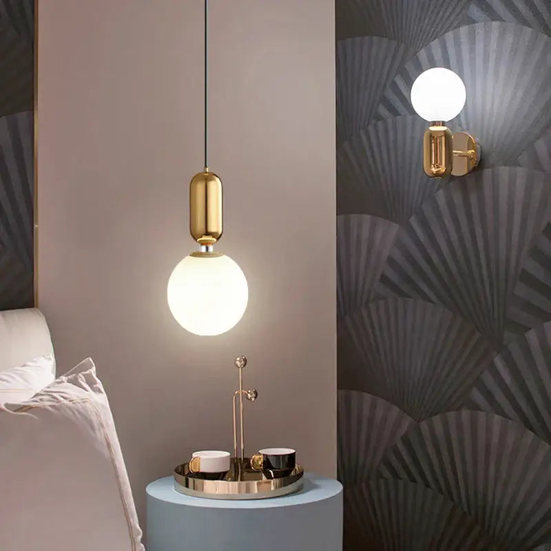 Gold-toned DecorBites LED glass ball pendant lights with a spherical frosted glass bulb and cylindrical metal fixture