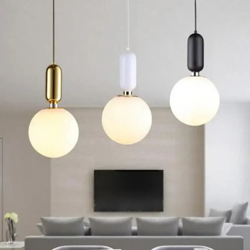 Three modern pendant lights with spherical frosted glass shades and gold white black metal fixtures from decorbites led glass ball