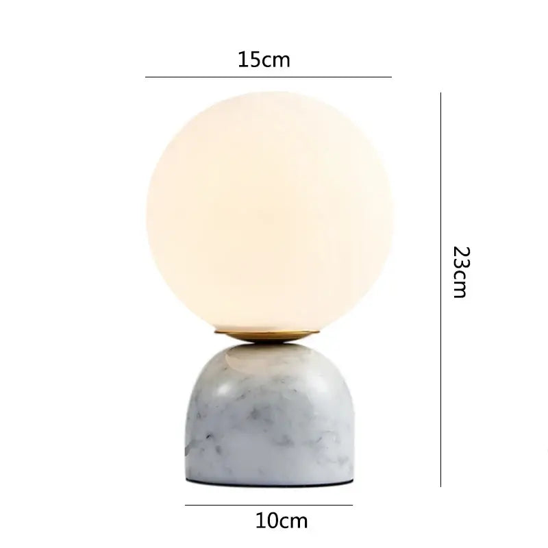 A sleek decorbites led glass ball table lamp with frosted glass globe and white marble base for home decor lighting