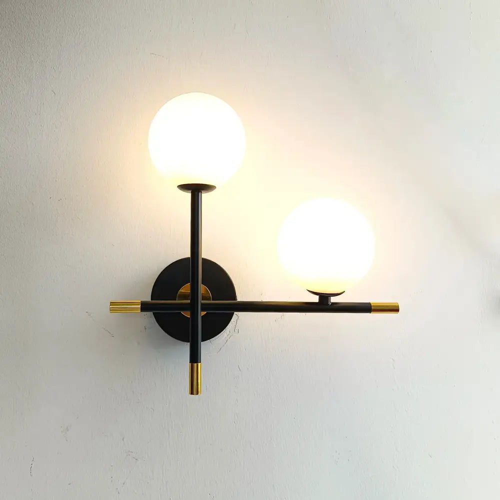 Modern black and brass decorbites led glass ball wall lamp with two frosted glass globe shades for bedroom lighting