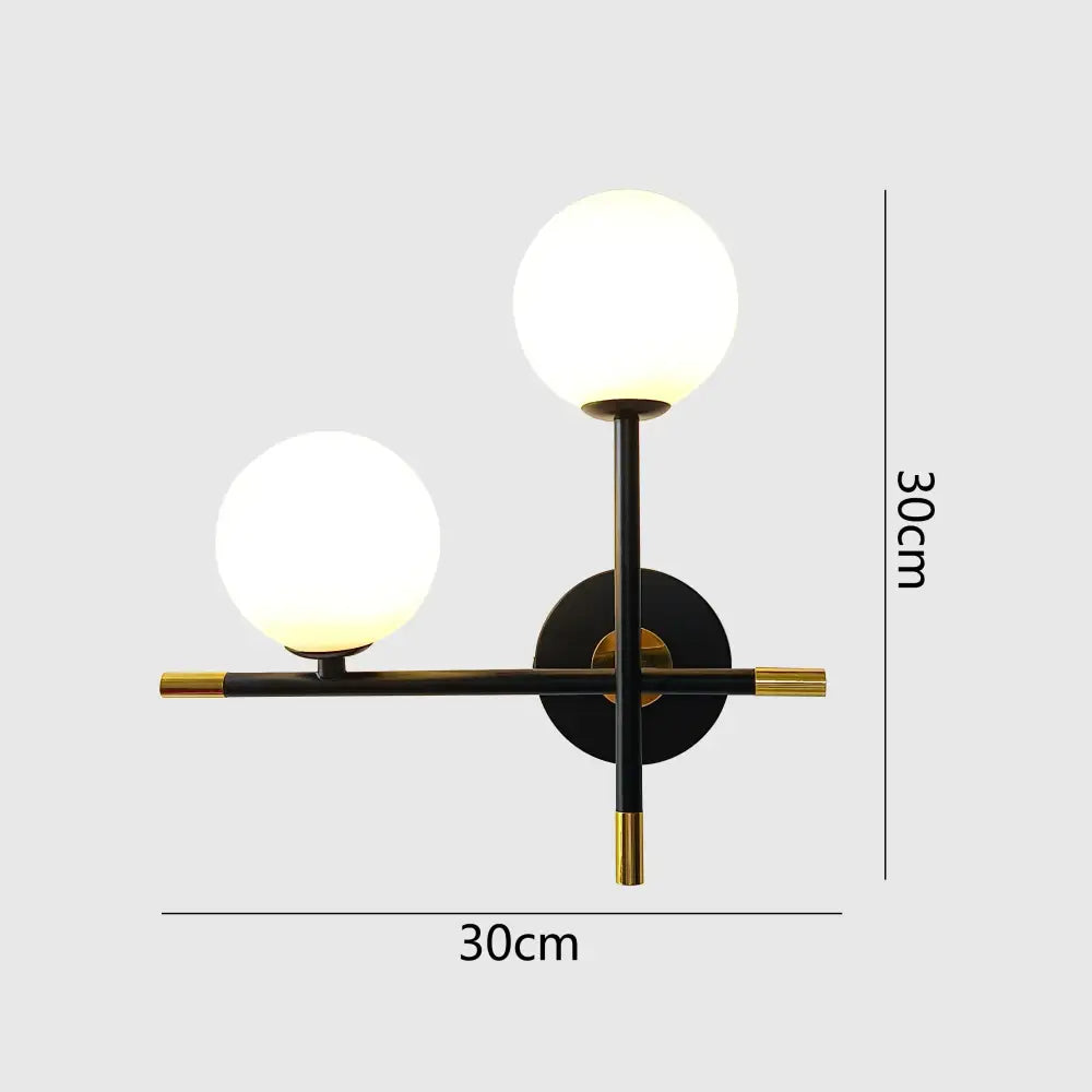 Modern black and brass DecorBites LED glass ball wall lamp with two frosted glass globe shades for bedroom lighting
