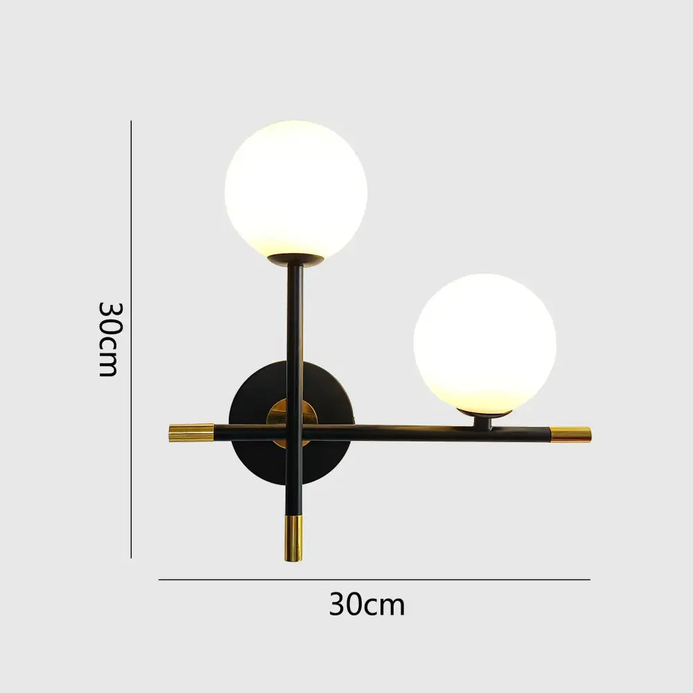 Modern black and brass decorbites led glass ball wall lamp with two glowing spherical shades for bedroom lighting