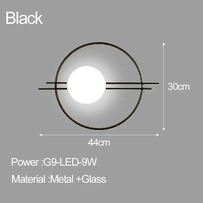 Black circular decorbites led glass ball wall sconce with glowing central led bulb and metal arm frame for bedroom or living room