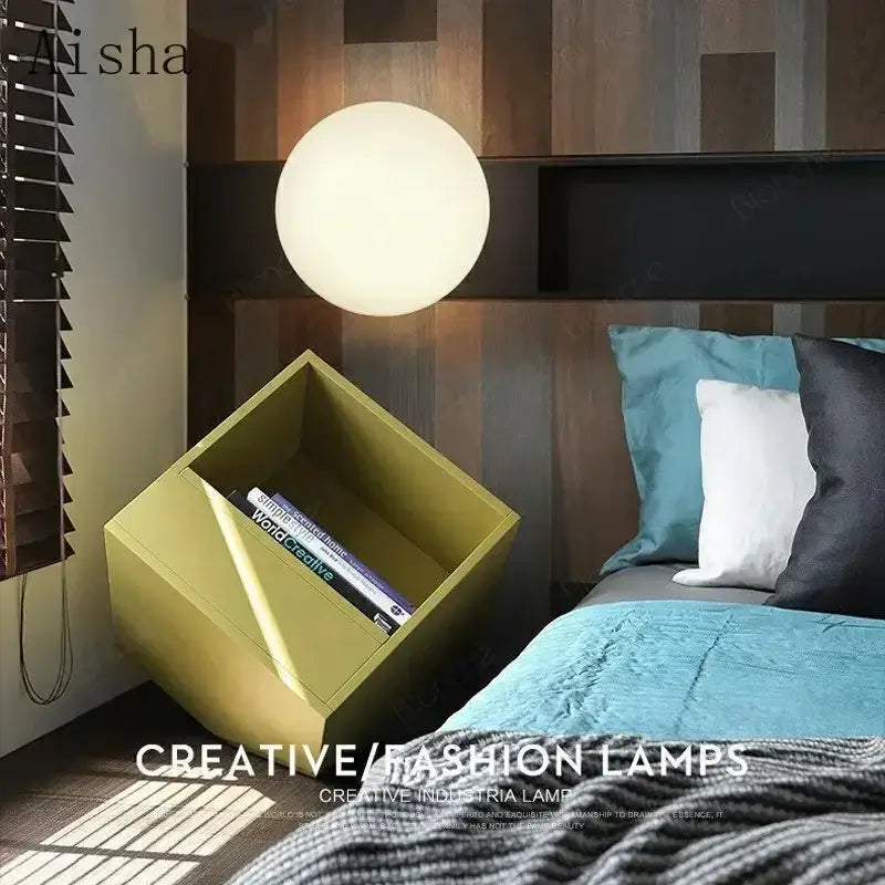 A sleek matte white decorbites led glass ball wall sconce with minimalist design hanging above a modern bed