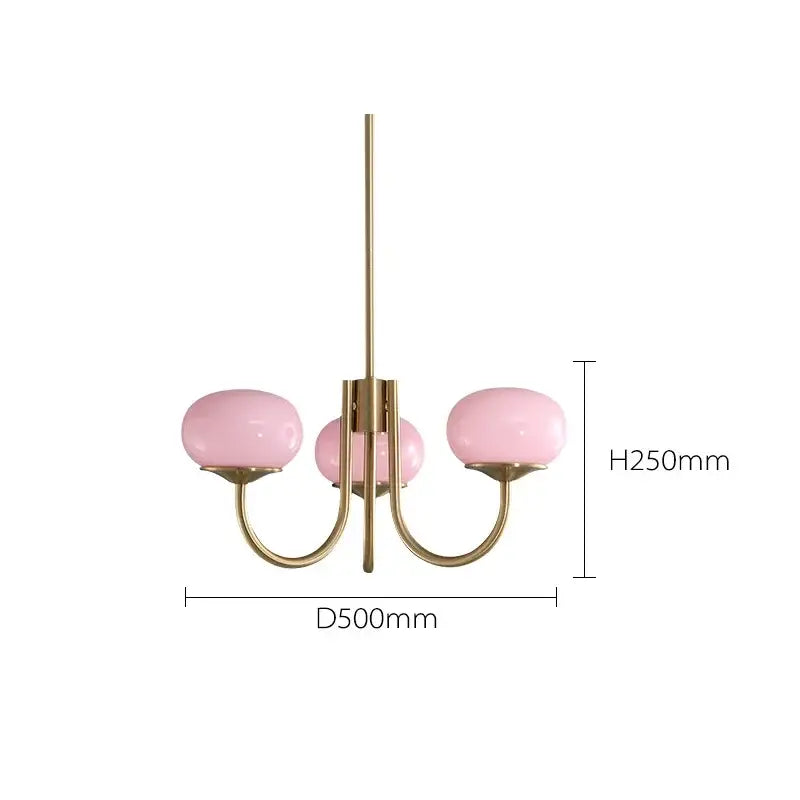 A delicate three-arm decorbites led glass chandelier with soft pink glass balls and brushed brass finish for home decor