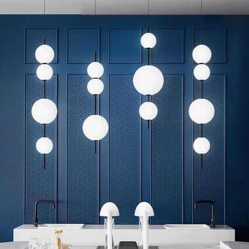 Modern white spherical decorbites led glass beads pendant chandelier with black rods against a deep blue wall