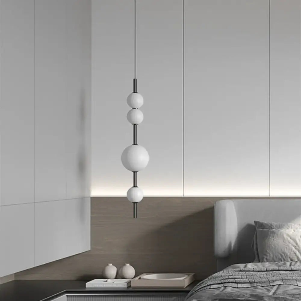 Decorbites led glass beads pendant chandelier with five matte white spherical bulbs on a black metal rod