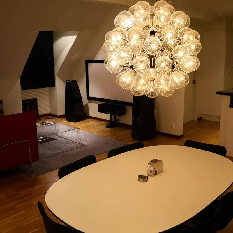 A decorbites led glass bubble chandelier in gold with clear glass bulbs arranged in a modern spherical cluster